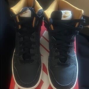 Nike Black and Gold Sneakers with Modern Design